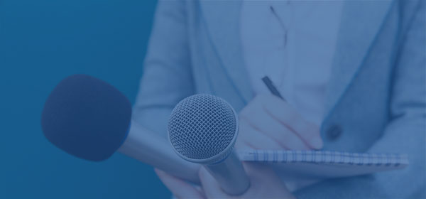 Person holding microphones and recorder