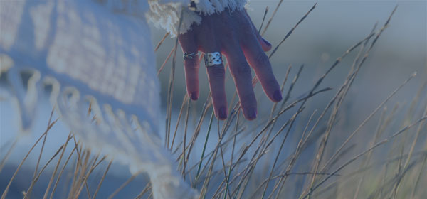 Hand touching tall grass